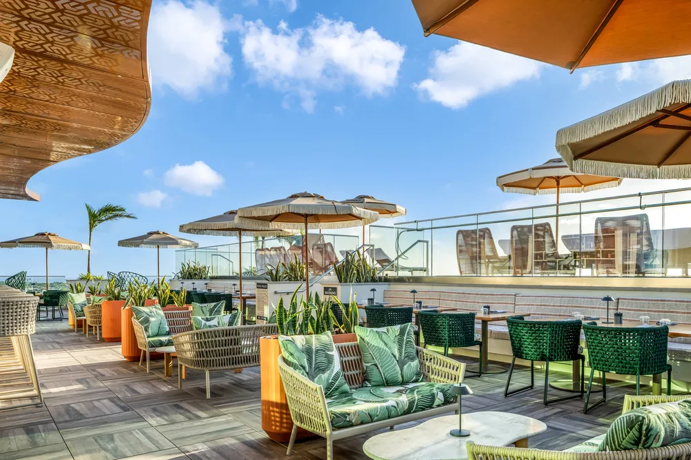 BYU at ONE | GT rooftop lounge by day with umbrellas and seating